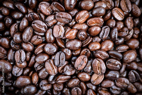 Fototapeta close up of roast coffee bean texture background with light and shadow, top view. coffee shop advertising background with copy space