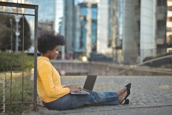Fototapeta woman on the street uses a computer