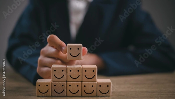 Fototapeta Hand putting wooden cube block shape with icon face smiley, The best excellent business services rating customer experience, Satisfaction survey concept