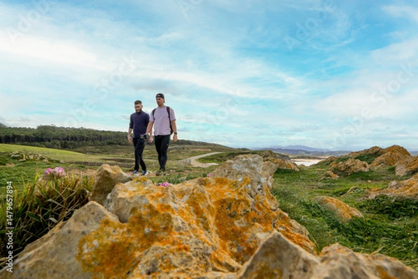 Obraz Two people walking through the landscape of the Costa Quebrada in Cantabria