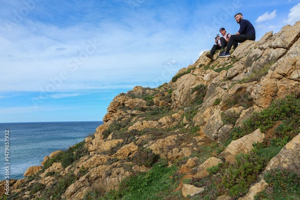 Obraz Two people walking through the landscape of the Costa Quebrada in Cantabria