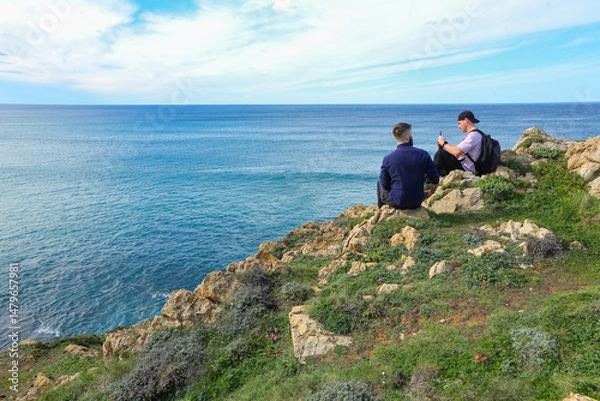 Obraz Two people walking through the landscape of the Costa Quebrada in Cantabria