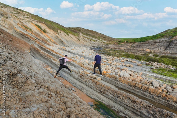 Obraz Two people walking through the landscape of the Costa Quebrada in Cantabria