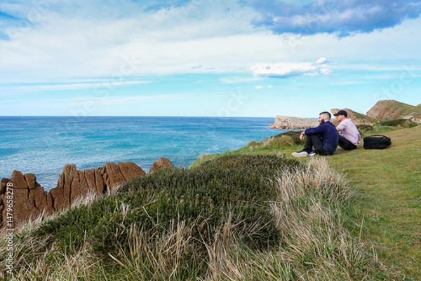 Obraz Two people walking through the landscape of the Costa Quebrada in Cantabria