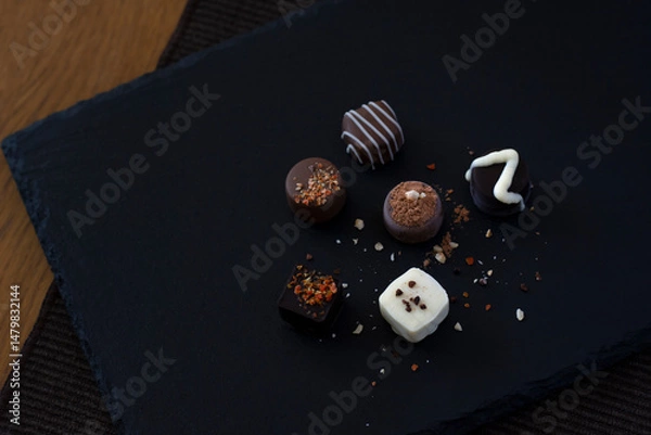 Obraz Handmade chocolates on a dark plate on the table