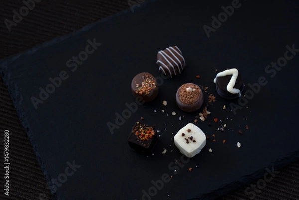 Obraz Chocolate assortment on a black tray