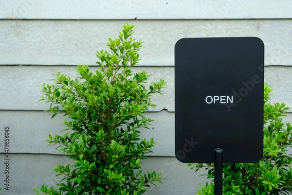 Fototapeta Exterior View of Open Business Sign on Textured Wall