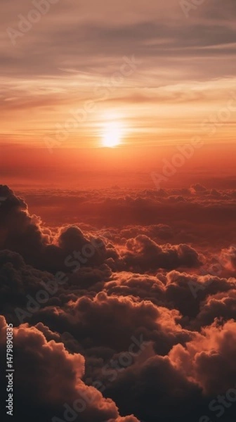 Fototapeta Stunning high-altitude perspective of colorful clouds illuminated by the warm light of a sunset or sunrise.