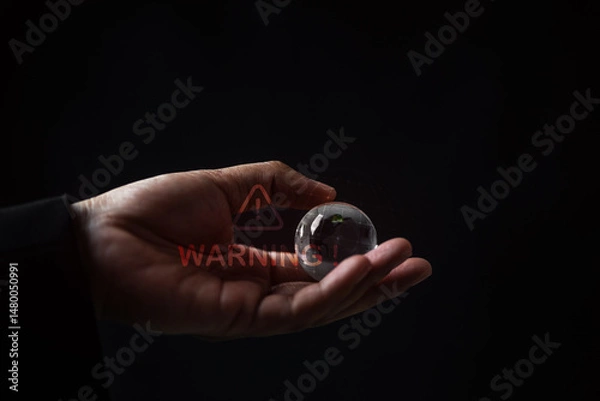 Fototapeta Hand holding a transparent sphere dark background still life photography minimalist environment close-up perspective