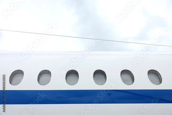 Fototapeta Airplane window from the outside at the airport.