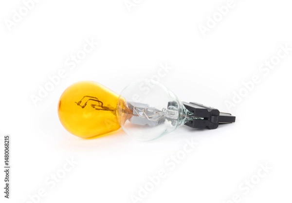 Fototapeta Yellow and clear miniature lightbulb. Turn signal light types for car headlight. Burned out yellow light. Turn signal bulb or indicator bulb. Selective focus. White background.