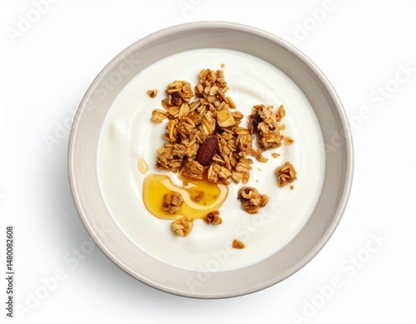 Fototapeta Creamy white yogurt bowl with granola and a drizzle of honey. A healthy breakfast overhead