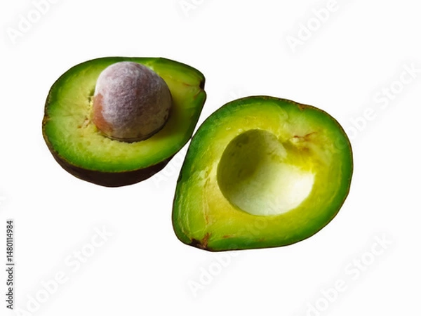 Fototapeta Avocado cut in half on white background showing fresh green fruit and seed