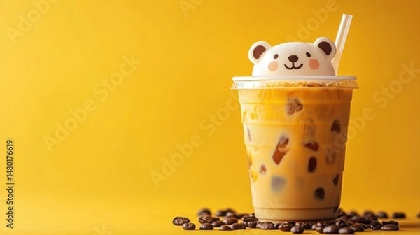 Obraz Cute bear topped iced coffee drink on vibrant yellow background with coffee beans scattered around