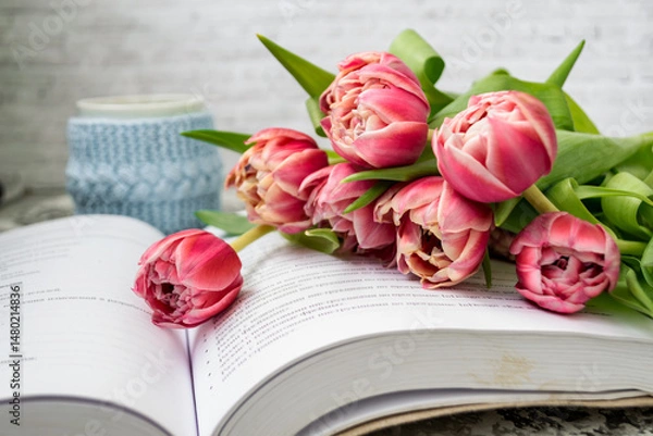 Fototapeta Pink tulips, an open book and a mug of freshly brewed coffee or tea. Spring set. Flatley layout.