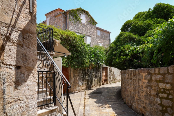 Fototapeta Narrow paved street in the Old Town of Budva, a walled coastal city built by the Venetian Republic along the coast of the Adriatic Sea in Montenegro