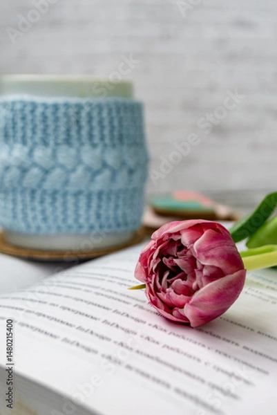 Fototapeta Pink tulips, an open book and a mug of freshly brewed coffee or tea. Spring set. Flatley layout.