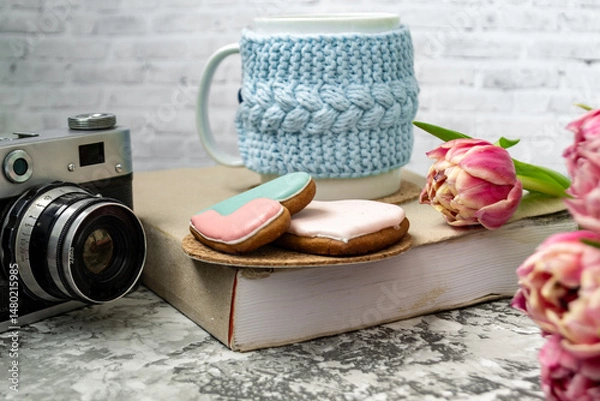 Fototapeta Pink tulips, an open book and a mug of freshly brewed coffee or tea. Spring set. Flatley layout.
