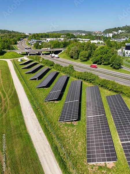 Obraz Aerial drone photo of photovoltaic solar panels next to the highway