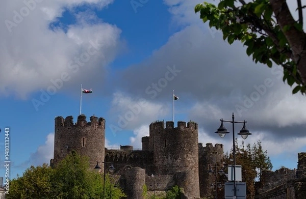 Fototapeta A picture of a castle under a partly cloudy sky. Conwy Castle - Conwy - Wales - Great Britain
