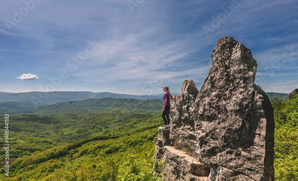 Fototapeta Woman Tourist Standing on Edge of Mountain Cliff