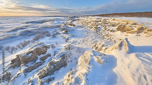 Obraz Snow-covered rocky landscape at sunset, showcasing natural formations and a serene winter atmosphere
