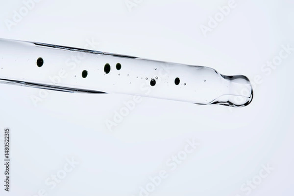 Fototapeta Soothing serum with natural green tea extract in a pipette.