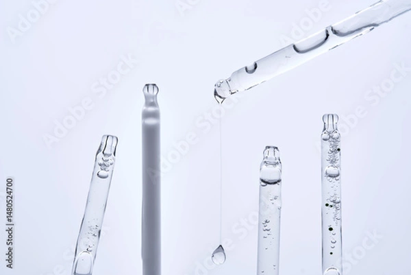 Fototapeta Five different droppers with facial serum in a row.