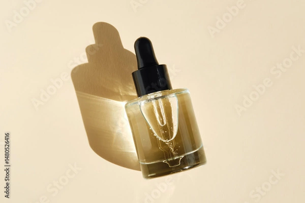 Fototapeta Oily serum with peptides on a beige background.