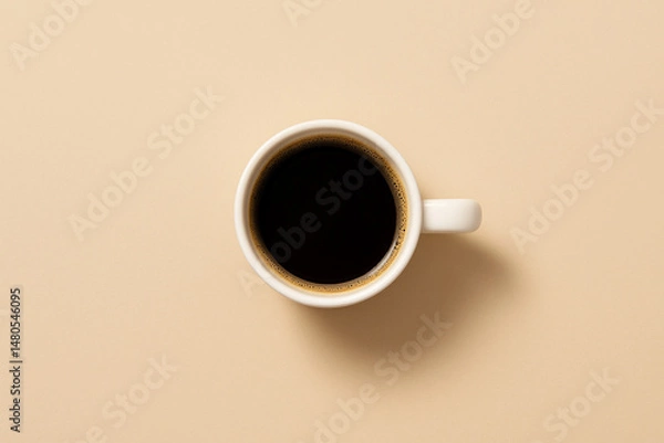 Obraz Top view of a white cup filled with black coffee placed on a neutral beige background