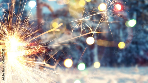 Obraz New Year or Christmas background with sparklers. Background of New Year's bokeh, Christmas mood, glitter, festive background.