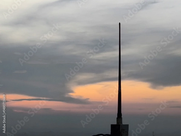 Obraz Towering spire pierces the twilight sky, silhouetted against pas