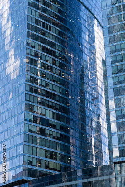 Fototapeta Glass skyscraper on a clear sunny day close-up