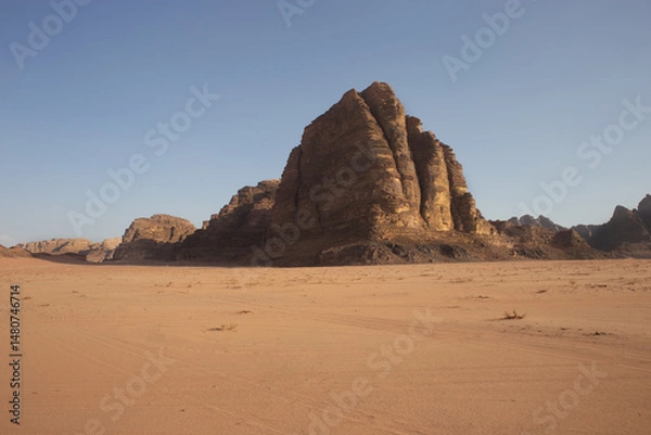 Fototapeta Rocky hillside against a clear blue sky. The sky is very bright, and the sun is shining. The desert is very hot for life, ecology, the heat is very high, there is no vegetation