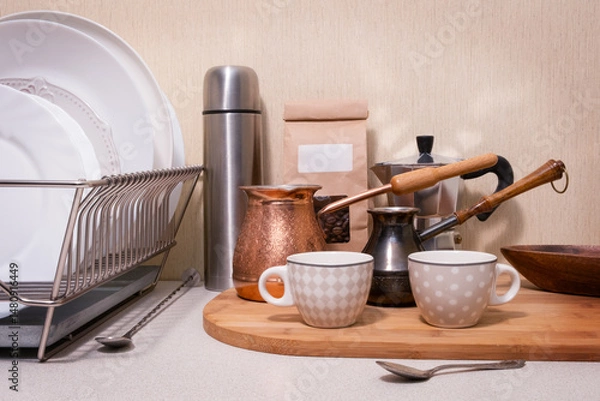 Obraz A kitchen counter with a wooden board and a silver dish rack
