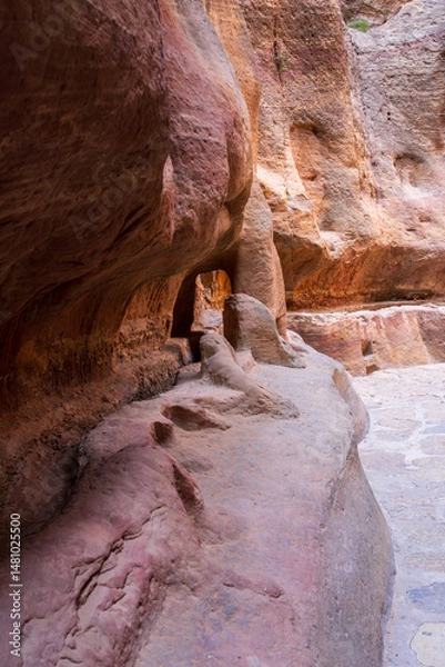 Obraz Carved water channels and pipes along the walls of the narrow gorge of the Siq entering Petra in Jordan