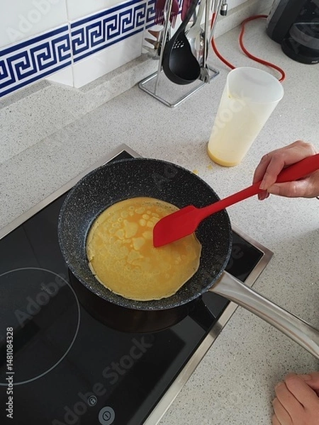 Obraz Top view of a woman cooking crepes 