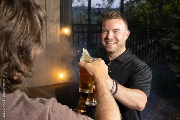 Obraz Friends celebrating and cheering with beer pints for National Beer Lover's Day.