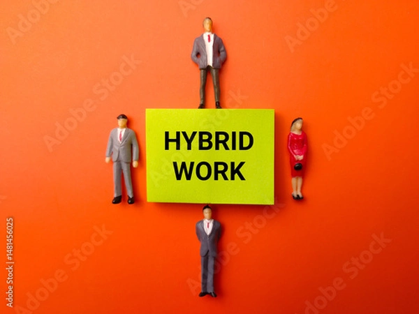 Fototapeta Miniature people and sticky note with the word Hybrid Work on a orange background
