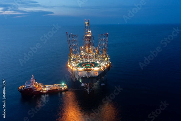Obraz Aerial view of offshore jack up drilling rig during sunset - oil and gas industry.