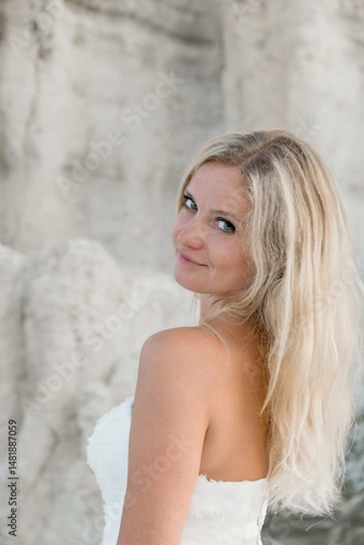 Obraz a woman in a white dress, a bride on a mountain with a blue sky. Beautiful nature, freedom, enjoyment of life. High quality photo