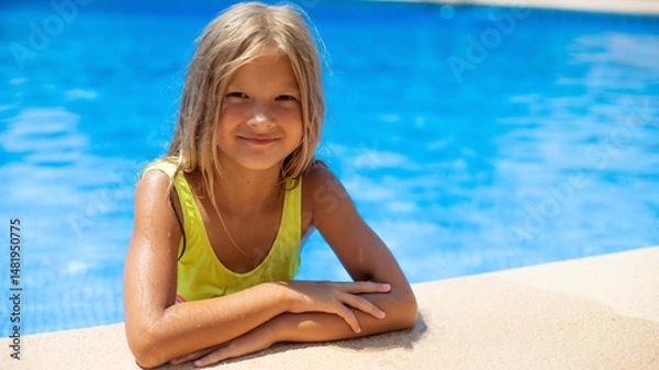 Fototapeta Portrait of smiling child girl enjoys sunny day by the pool in a vibrant yellow swimsuit