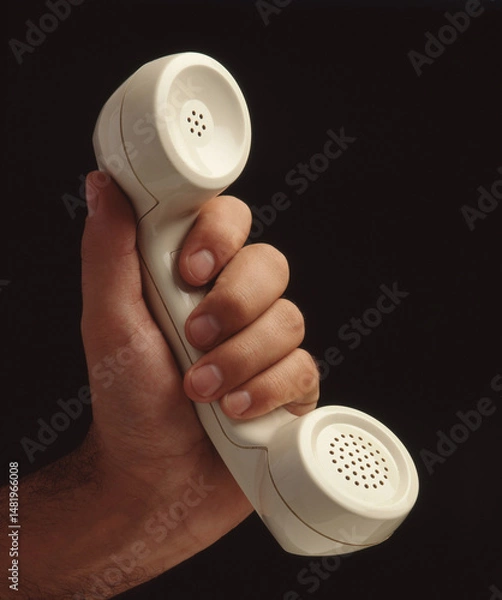 Obraz Hand hold retro telephone handset on black background.