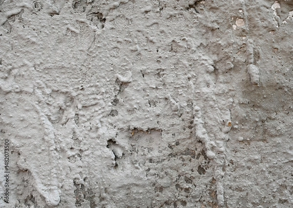 Fototapeta Textured wall with plaster covering showcasing intricate patterns and colors in a rustic setting