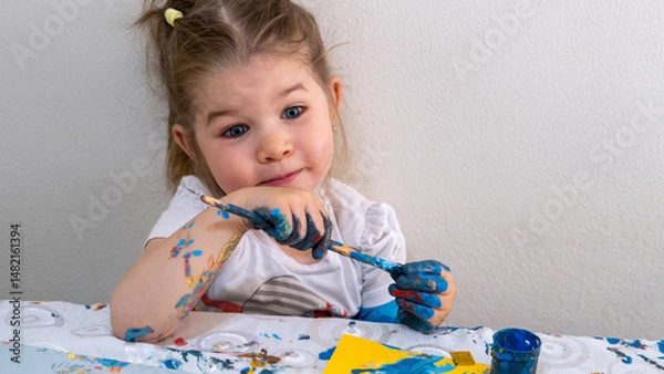 Fototapeta Happy Little Girl Engaged in Creative Finger Painting and Arts and Crafts Activities, Exploring Colors, Textures, and Shapes for Early Childhood Education, Fun Learning