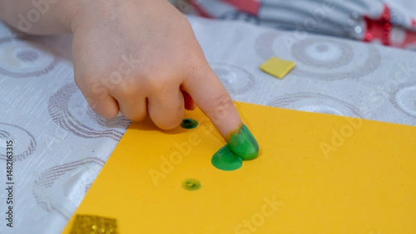 Fototapeta Colorful Finger Painting Activity for Kids with Bright Yellow Paint and Creative Learning Environment on White Background, Early Childhood Education Concept