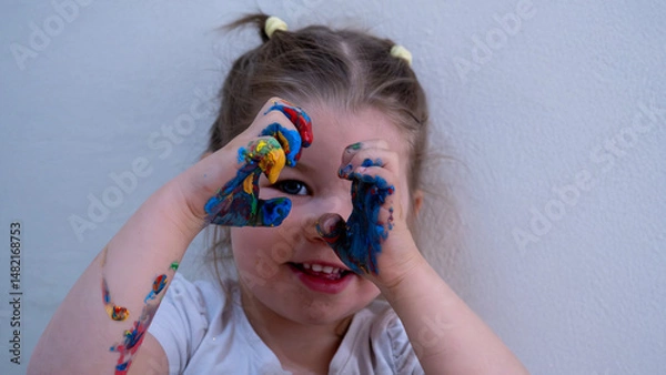 Fototapeta Joyful Little Girl Having Fun with Colorful Finger Paints, Expressing Creativity and Imagination, Hands Covered in Vibrant Paint, Art and Early Childhood Education Concept