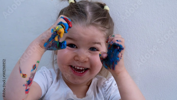 Fototapeta Happy Smiling Child Playing with Bright Finger Paint Colors, Early Childhood Artistic Expression, Fun Learning Activity, Creative Educational Development for Kids