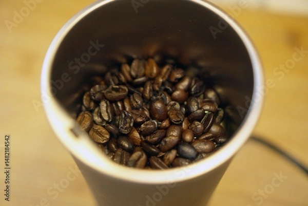 Obraz Freshly roasted coffee beans in a cup.