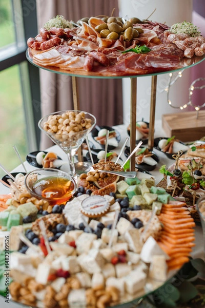 Fototapeta Wedding day. Buffet table with various types of snacks and sweets in the celebration hall